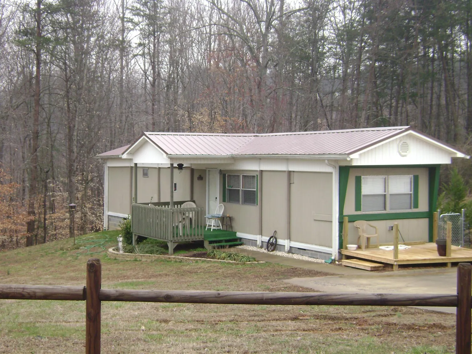 Mauve metal roof on a manufactured home with a new front deck in Garden City